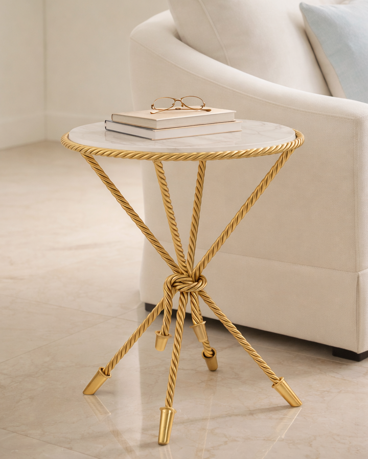 Gold side table with marble top in a living room setting
