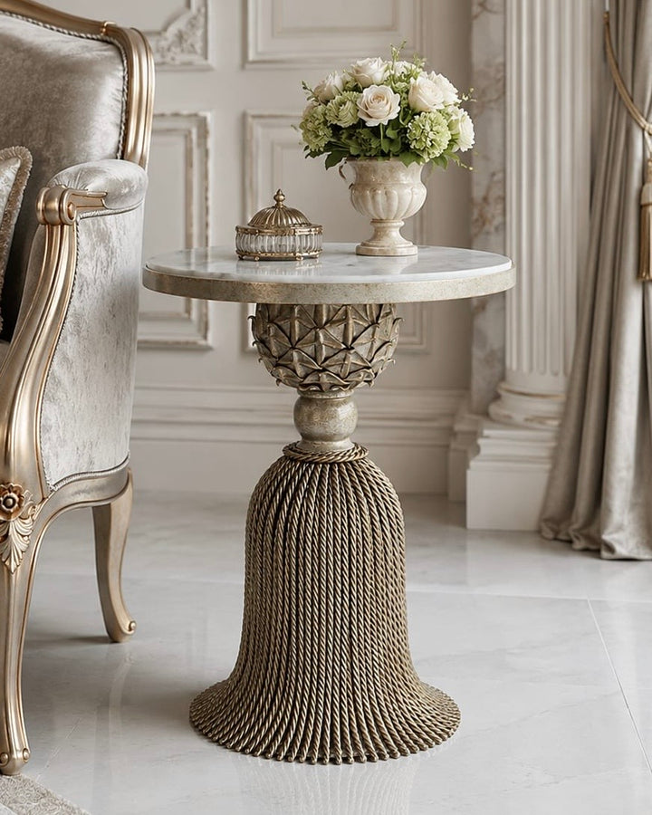 Isadora silver wrought iron side table with sculptural tassel base, white marble top, and floral detailing in an elegant classic interior.