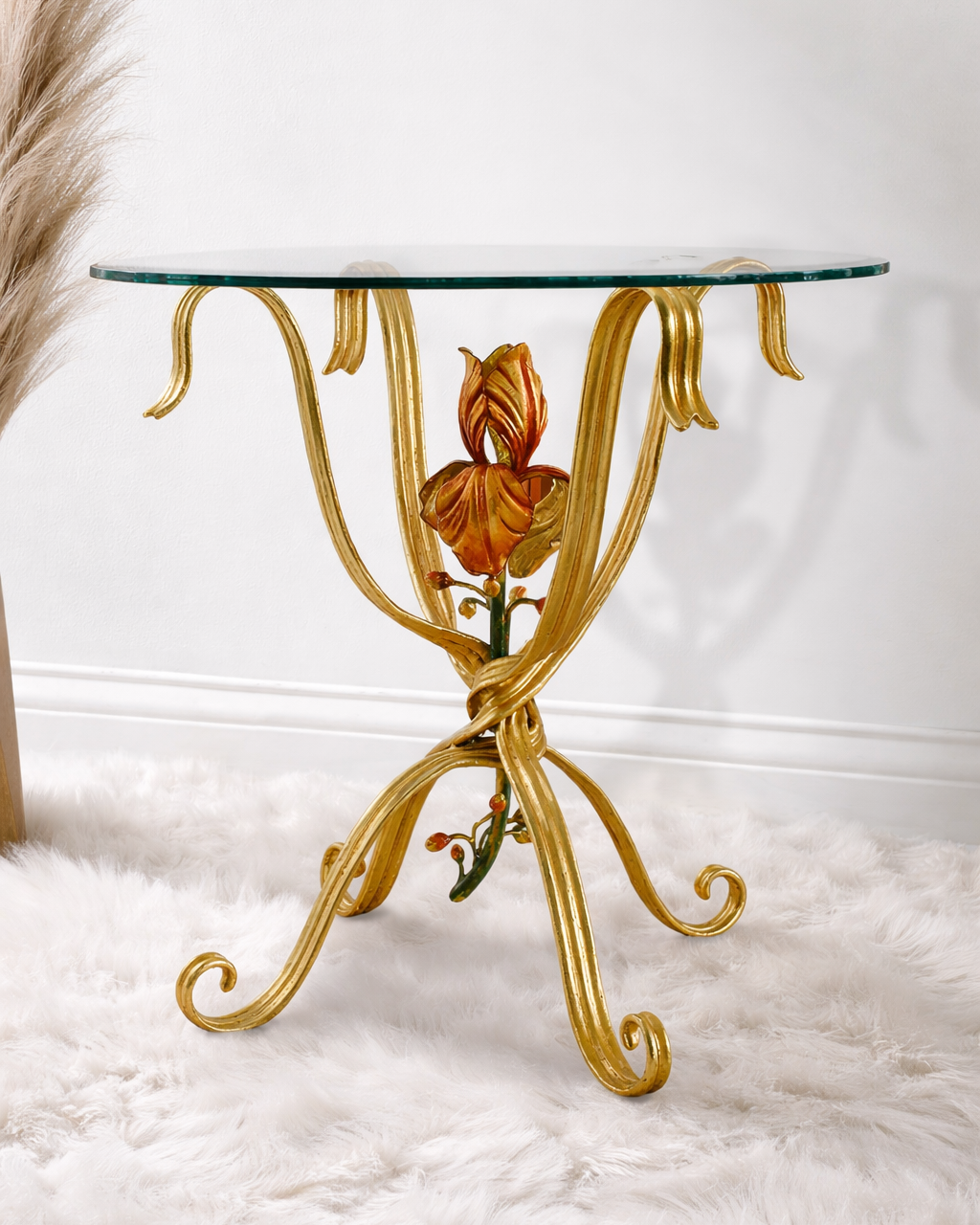 Jolie side table with sculpted floral centerpiece in forged metal and round glass top.