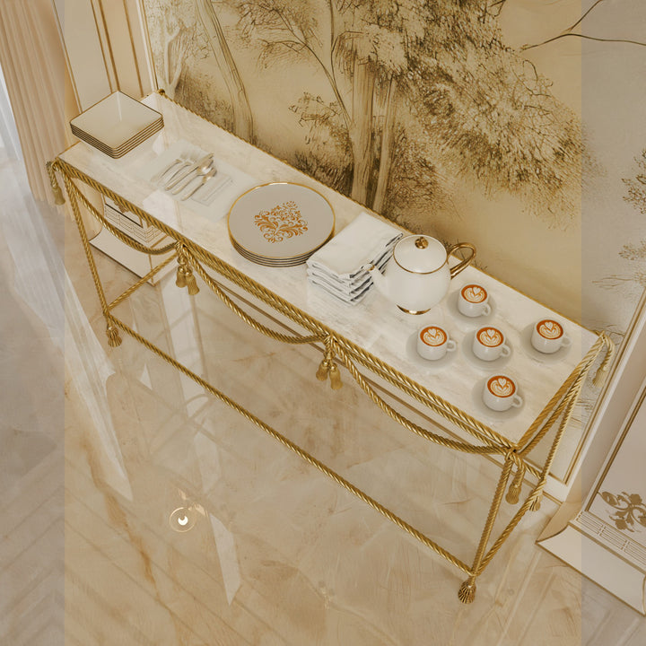 Decorative table with gold accents, plates, and coffee cups in a stylish interior setting.