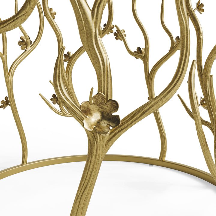 Close-up of sculpted metal flowers and branches on gold blossom side table