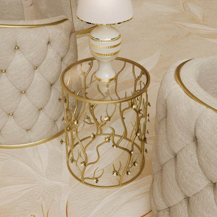 Blossom side table styled with a white and gold lamp, surrounded by tufted chairs in a luxury interior