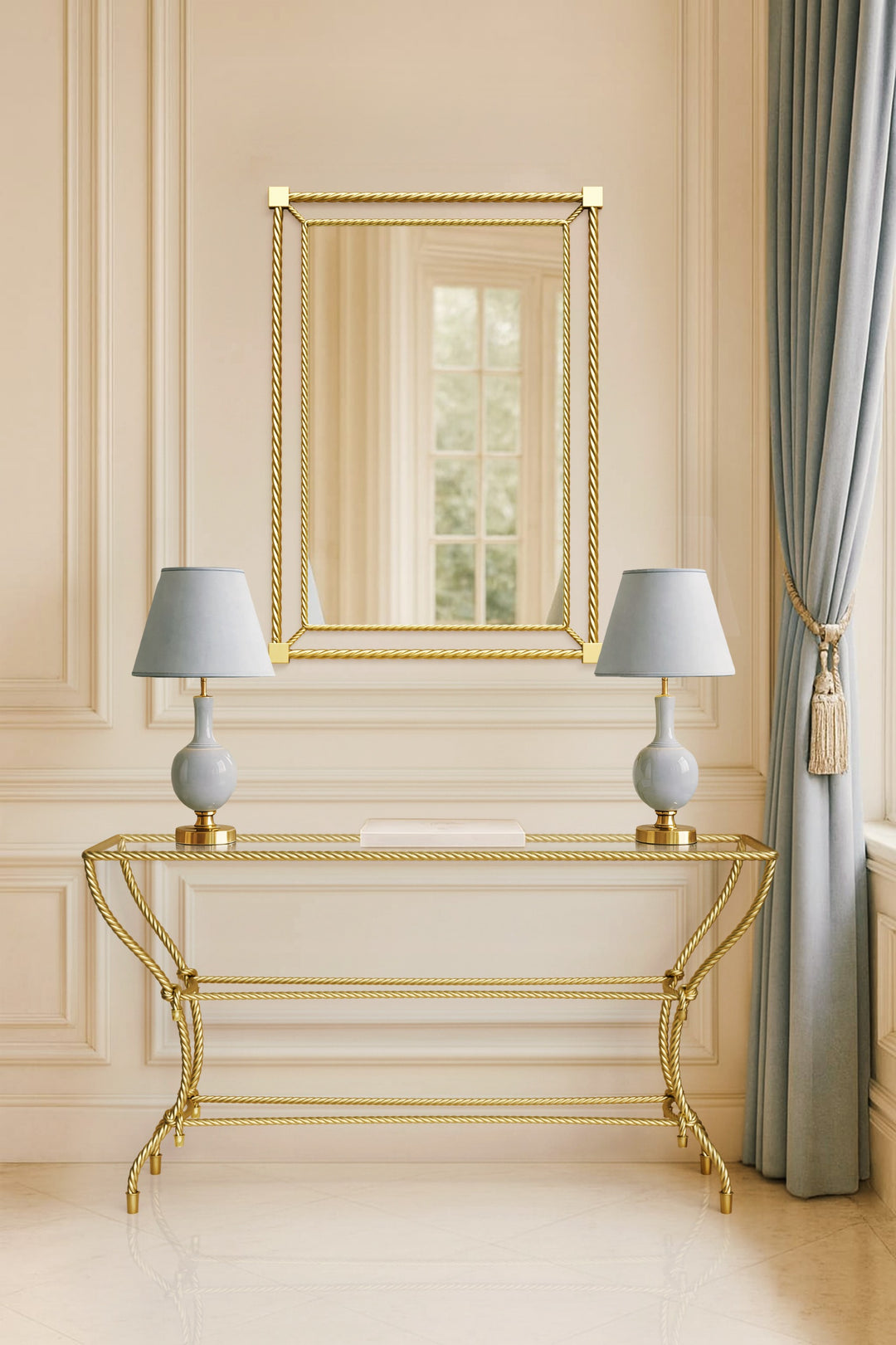 Noura console table in gold finish, featuring rope-inspired metalwork and paired with a matching mirror in a classical interior setting.