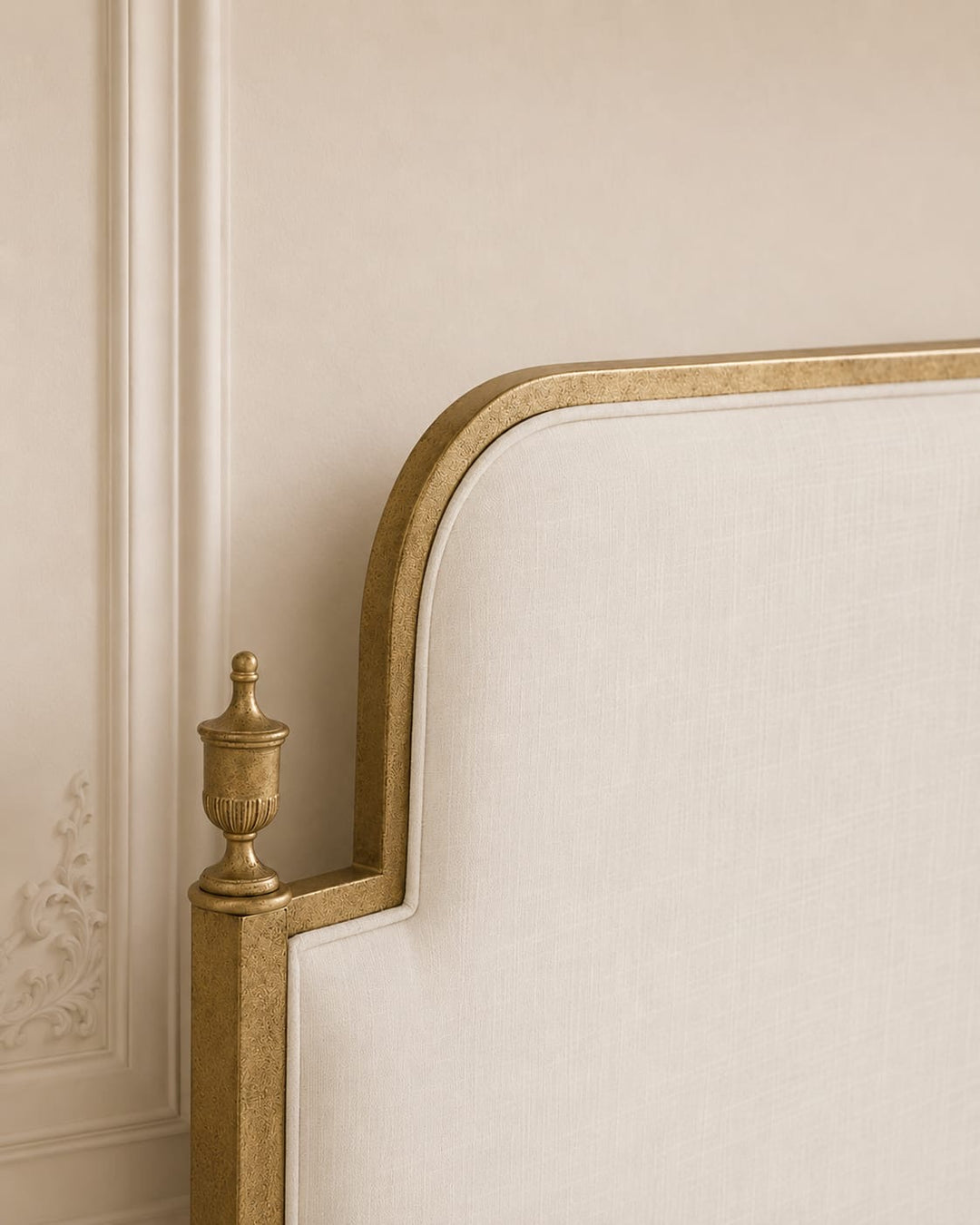 Close-up of Evita upholstered headboard with refined metal detailing