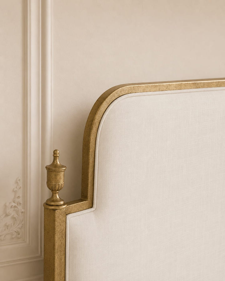 Close-up of Evita upholstered headboard with refined metal detailing