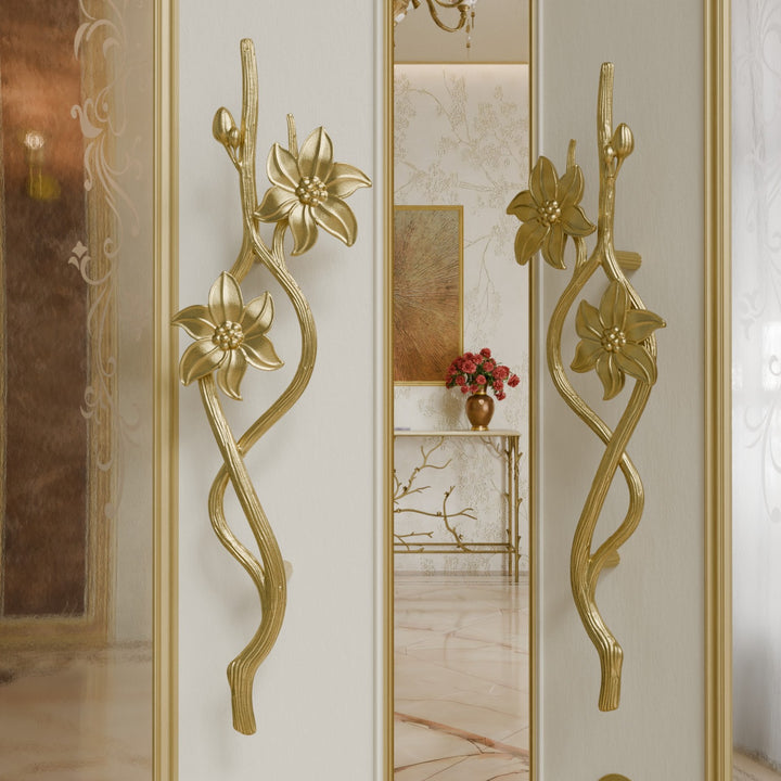 Jasmine door handles in gold finish with floral and vine-inspired design on open luxury door