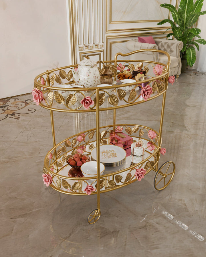 Juliet serving trolley in gold with hand-forged pink rose and leaf detailing, displayed in a refined classical interior