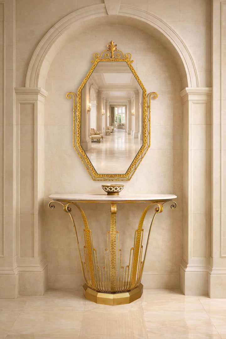 Lily art deco inspired console table and mirror in gold metal with marble top, styled beneath a classical arched niche in an elegant luxury interior
