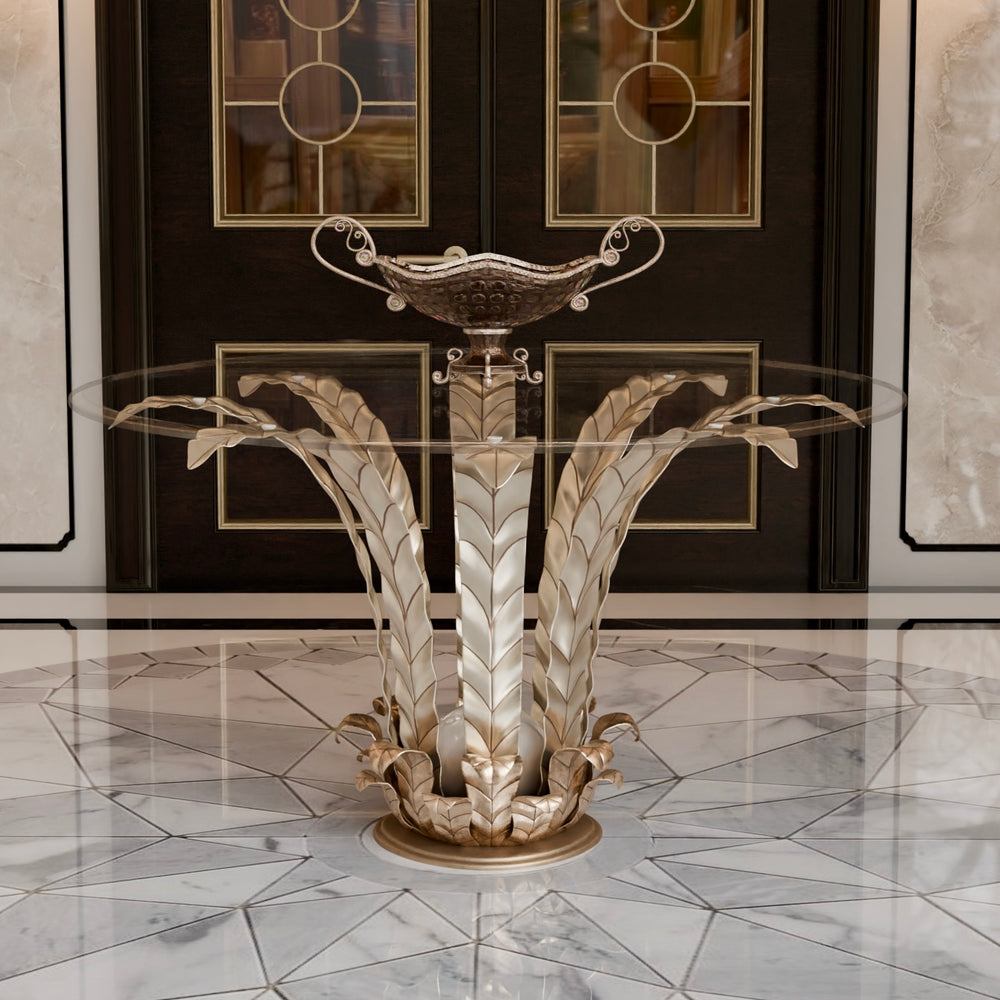 Lola entrance lobby table with a glass top and handcrafted wrought iron base featuring decorative leaves