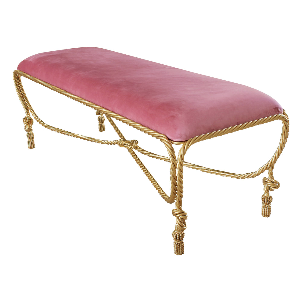 A contemporary metal golden bench with rope themed legs, topped with pink velvet upholstery