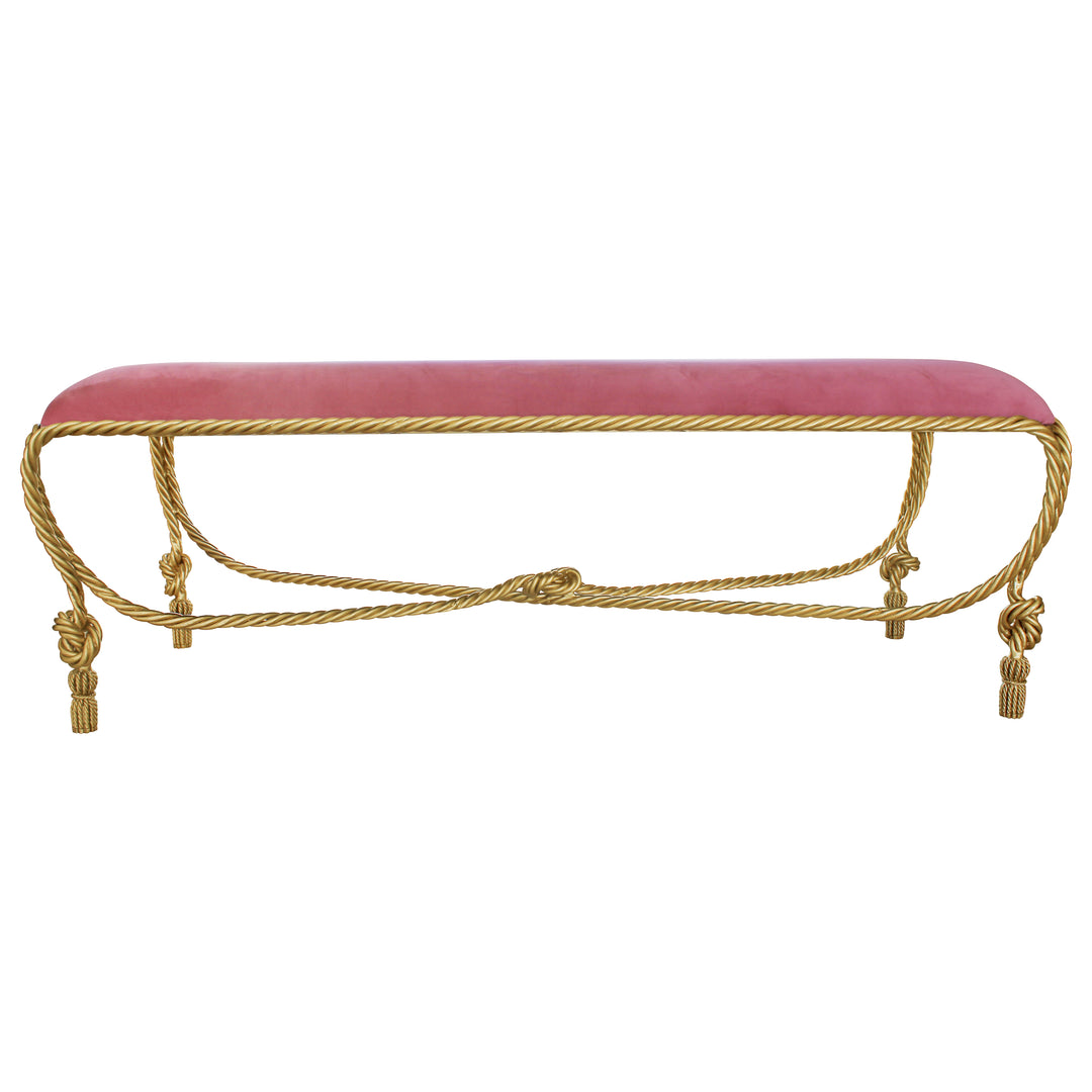 A contemporary metal golden bench with rope styled legs, topped with a pink velvet cushion