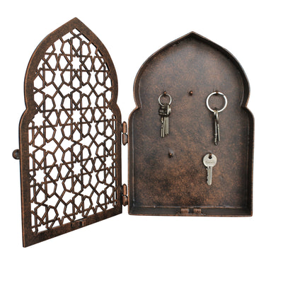 A decorative key holder with an Islamic design pattern painted in an antique bronze finish