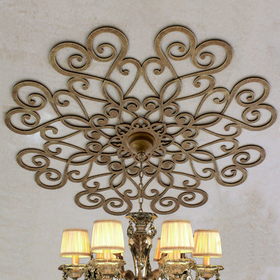 Decorative metal ceiling medallion with a chandelier hanging from the center; painted in an antique bronze finish