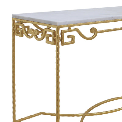 Close up of classical wrought iron console table with golden scrolls and textured legs topped with marble