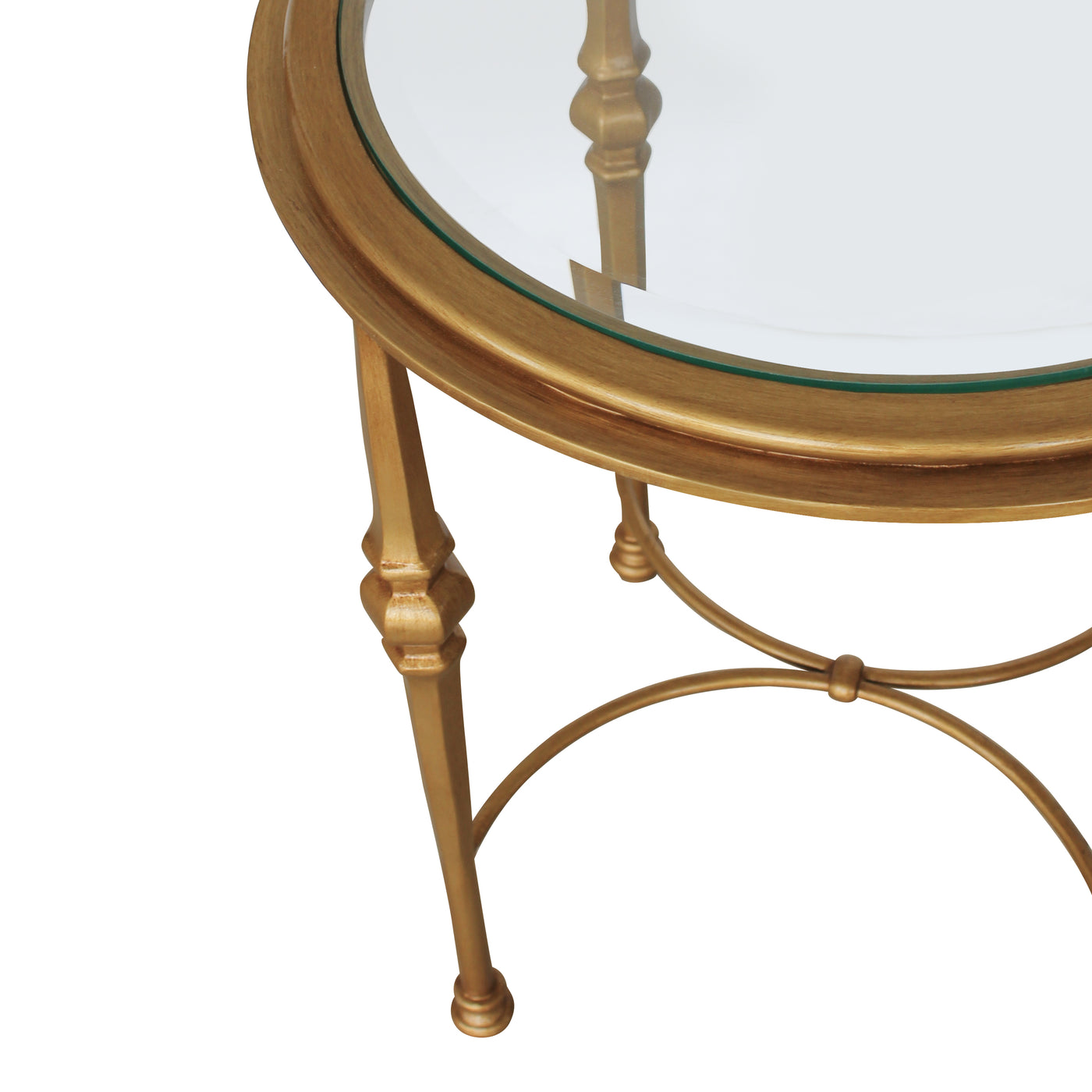 Close up of a classical round end table with glass top painted in antique gold finish