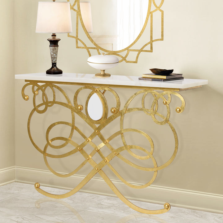 A luxurious handmade metal console table inspired by musical notes in a gold leaf finish, topped with white marble