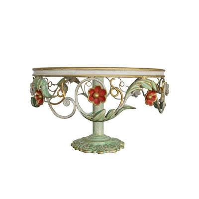 A round decorative cake stand with a base adorned with leaves and red flowers inspired from nature