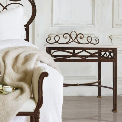 A luxurious wrought iron bedside table with an organic style painted in antique bronze