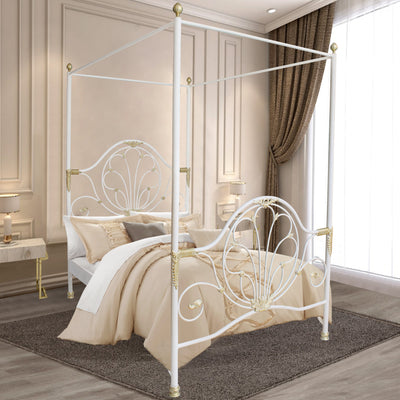 A contemporary wrought iron single canopy bed with large scrolls and leaf motifs, painted in a white and gold finish