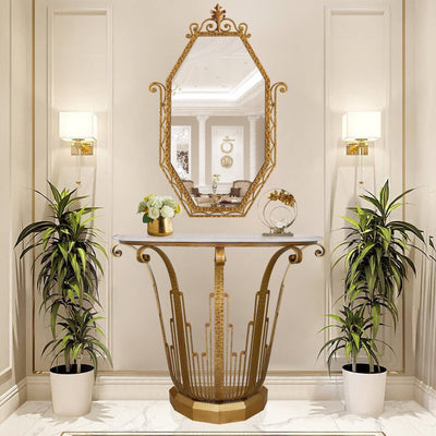 An Art Deco styled wrought iron console table and mirror painted in an antique golden finish in a luxurious living space