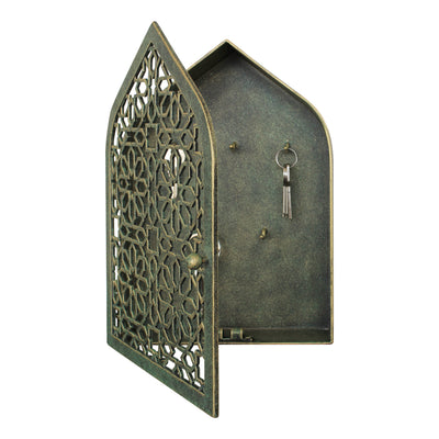 A wall mounted opened key cabinet with a geometric pattern and Islamic arched top painted in an antique green-gold finish