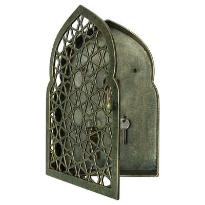 Frontal view of an opened key cabinet with a geometric pattern and Islamic arched top painted in an antique green-gold finish
