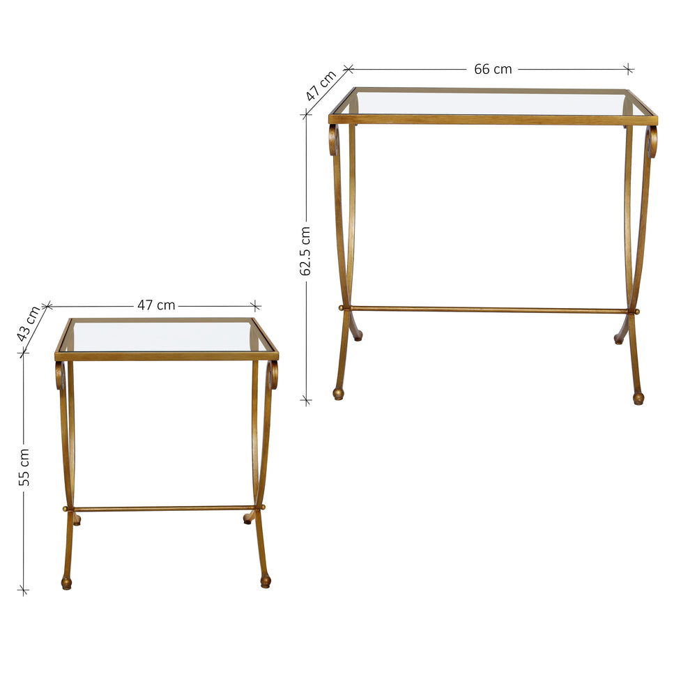A set of two wrought iron nesting tables with long scrolled legs painted in antique gold, topped with glass with annotated dimensions