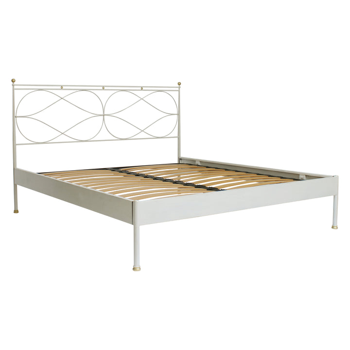 A contemporary metal king sized bed painted in white and hints of gold