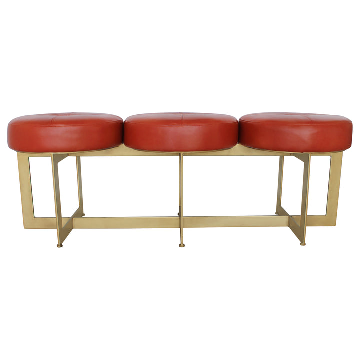 Modern bench with a metal gold base topped with red leather upholstery