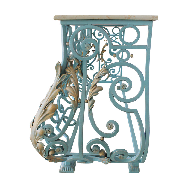 Side view of a classical console base made up of blue wrought iron scrolls and gold leaves