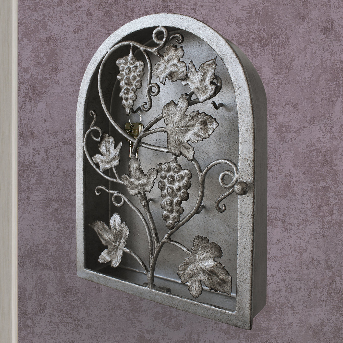 Side view of arched rustic key cabinet inspired from grape vines painted in antique silver