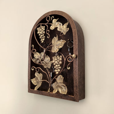Side view of arched rustic key cabinet inspired from grape vines painted in antique bronze and gold tones