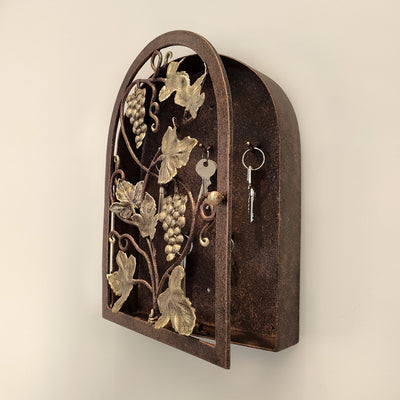 Side view of arched rustic key cabinet inspired from grape vines painted in antique bronze and gold tones